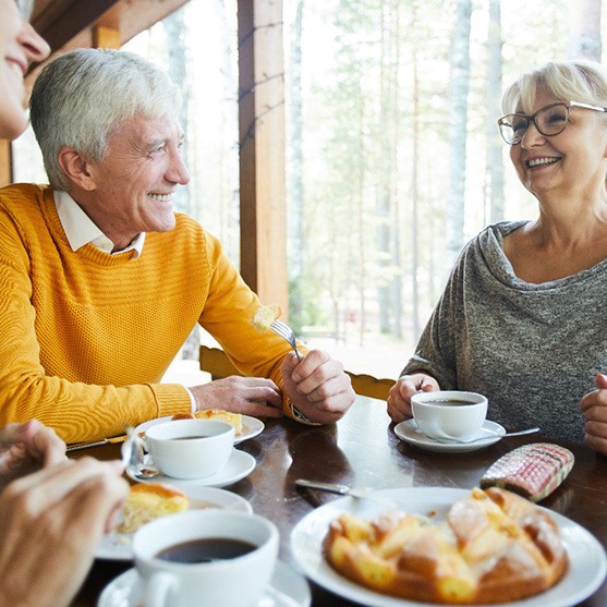 Mature friends eating a meal together