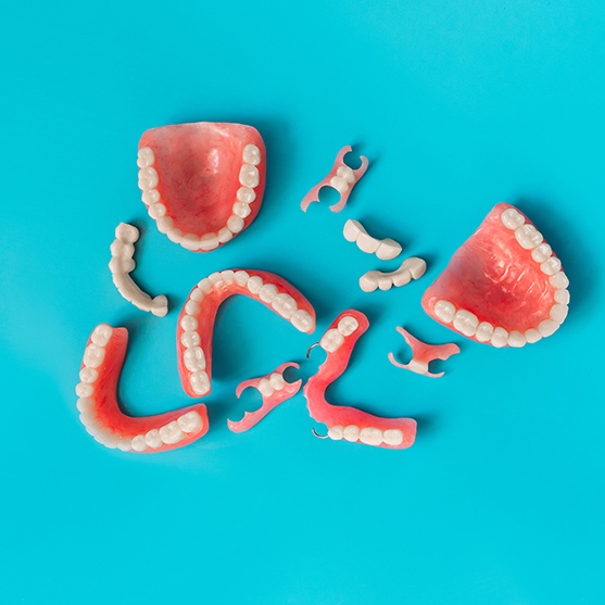 Bird’s eye view of full and partial dentures on a light blue background