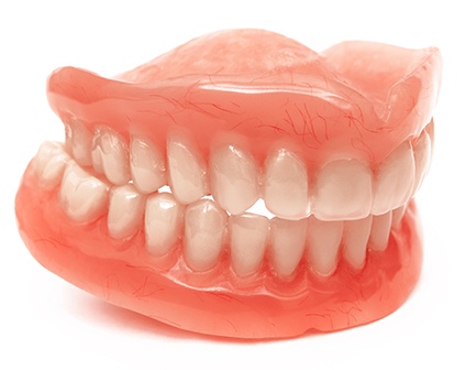 Full set of dentures biting together with white background