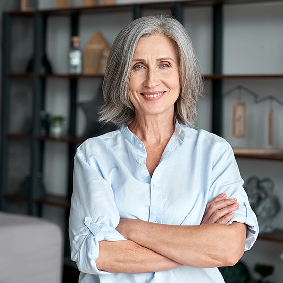 Senior woman smiling with arms folded