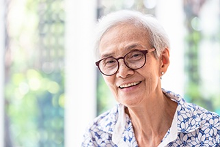 older woman with glasses smiling